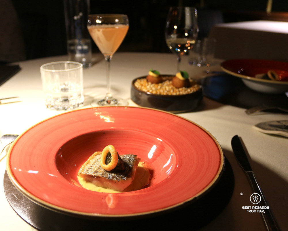 Wild striped bass in a coral plate at Le Clan in Quebec City.