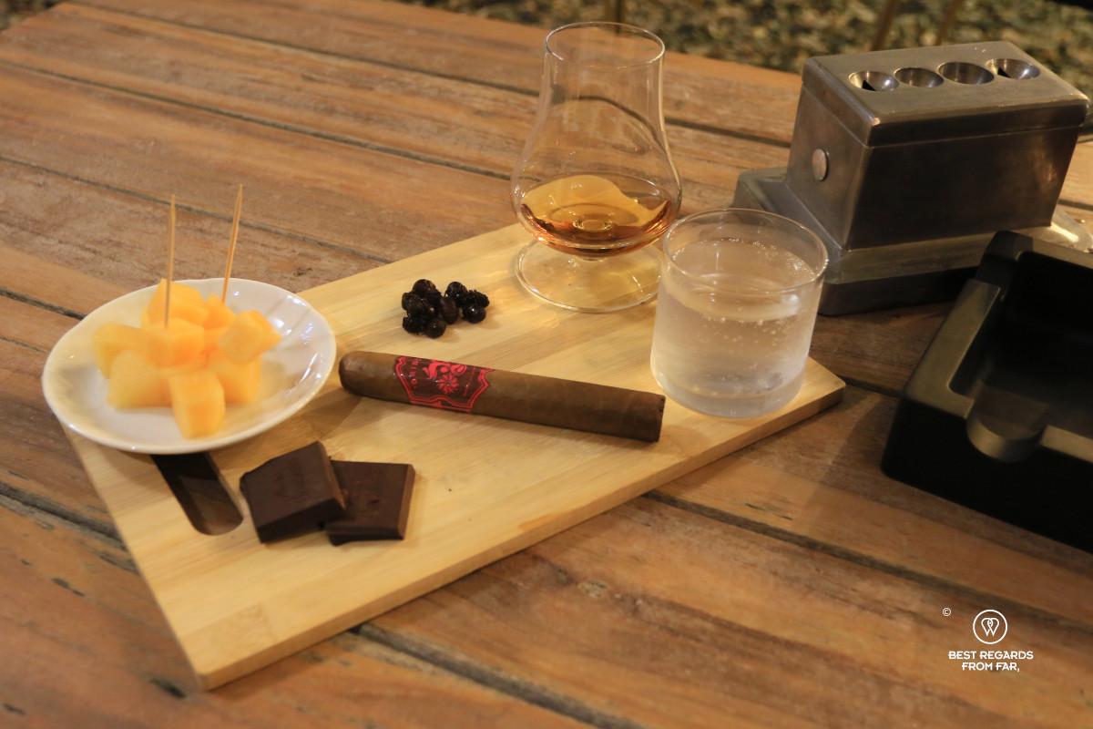 Bribon Cigar on a plank with melon, rum, chocolate and fat-bottomed ants.