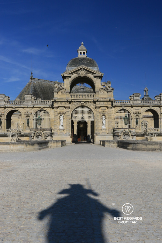 Shadow of the statue of a horse by the entrance of the Castle of Chantilly.