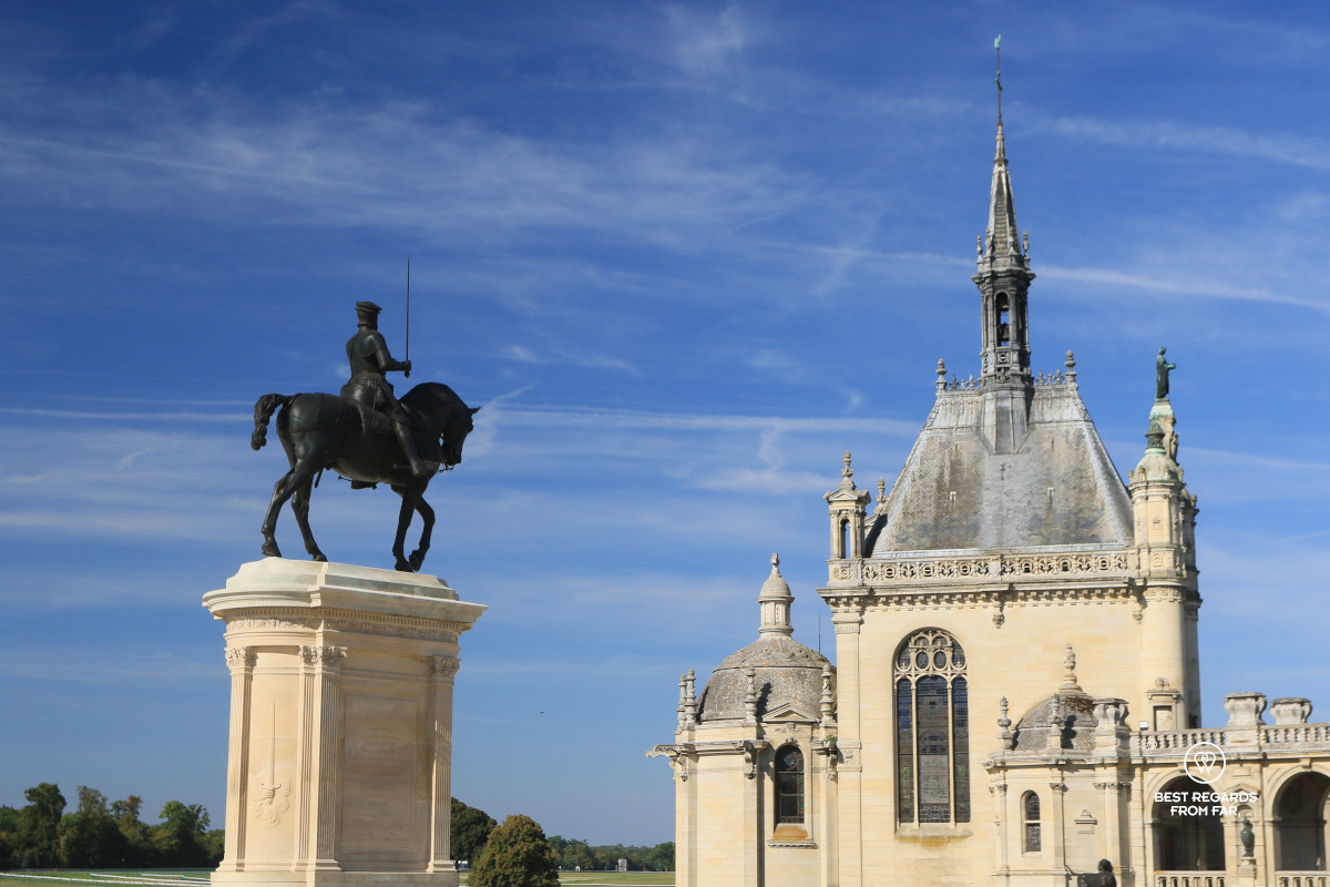 Castle of Chantilly with an equestrian statue.