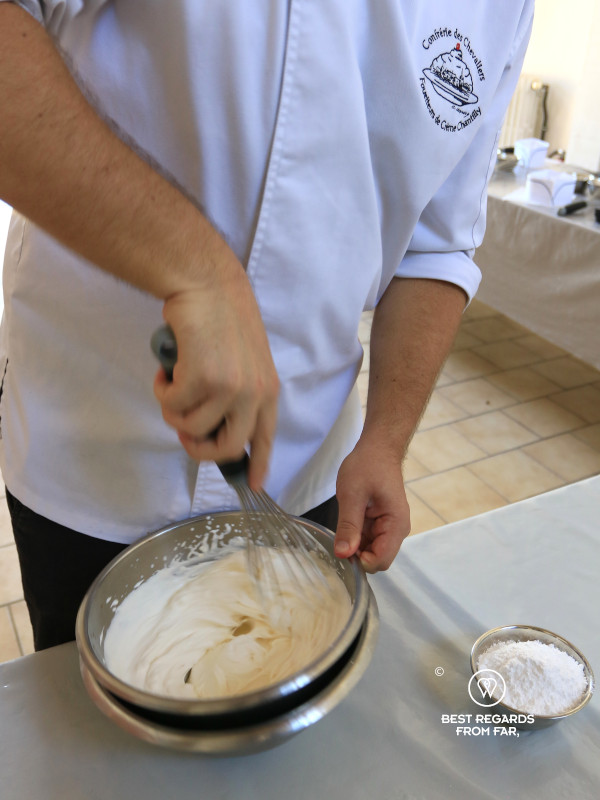 A knight of the Conférie des Chevaliers Fouetteurs de Crème Chantilly whipping cream.