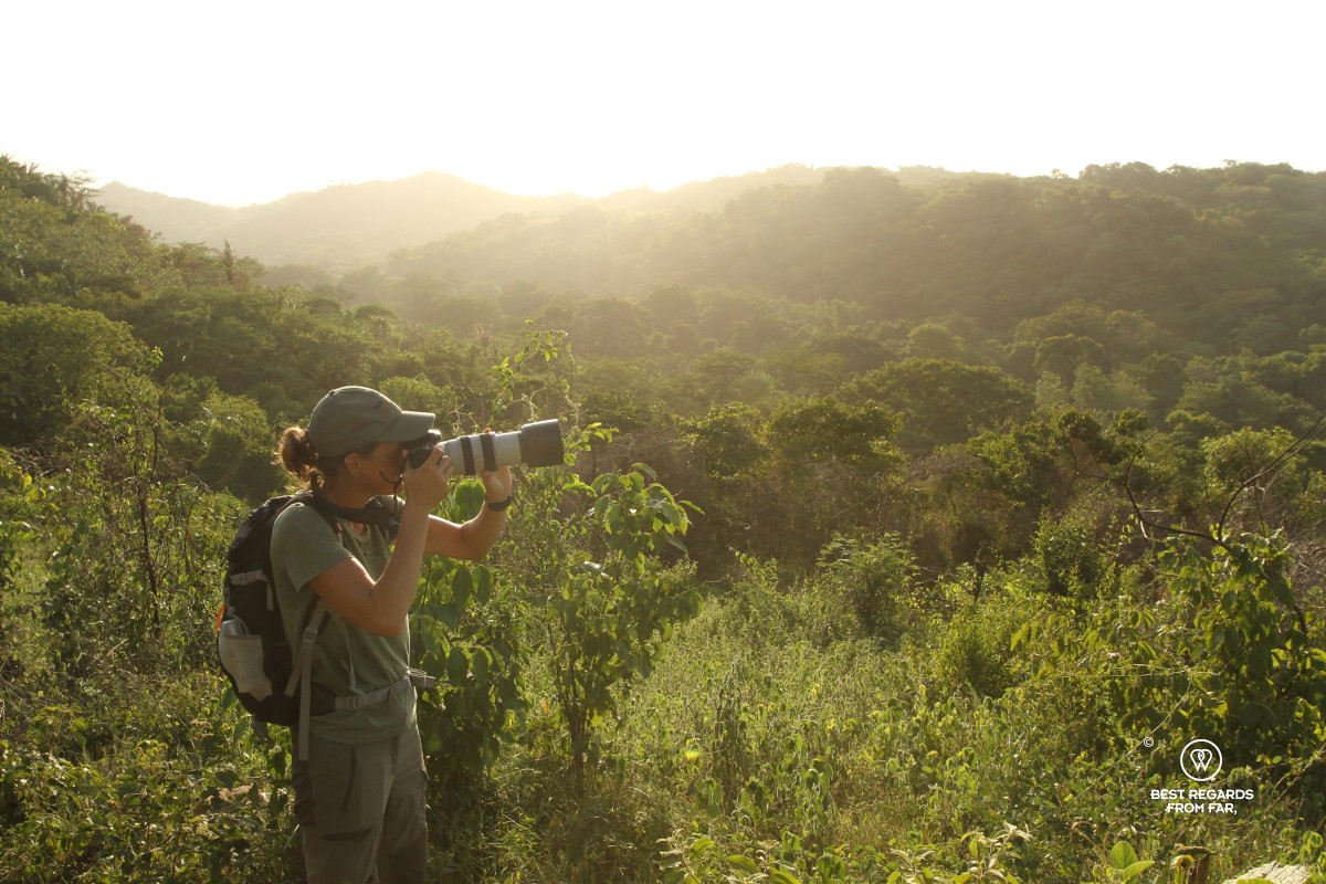 Photographer Marcella van Alphen taking a photo of the jungle of northern COlombia at sunset.