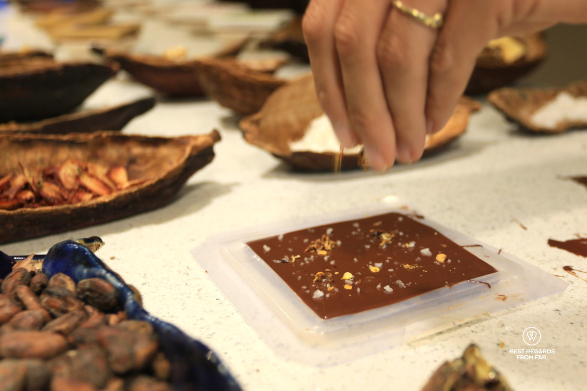 Sprinkling chili on a just-made chocolate bar in Quito.