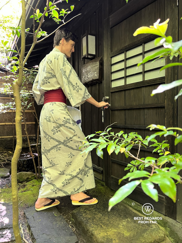 Woman in yukata entering an onsen.