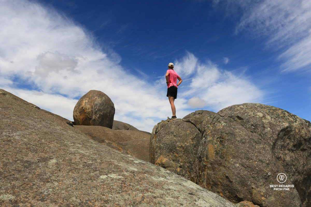 Hiker on and amongst by granite boulders on Paarl Rock in Paarl in South Africa.