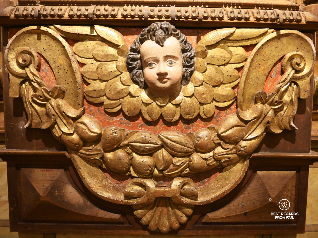 Angel and coffee beans and cacao pods inside the San Francisco Church in Quito.