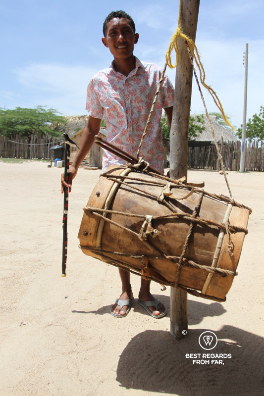 Wayuu young man by a drum in a rancheria in SFF Los Flamencos in Colombia.