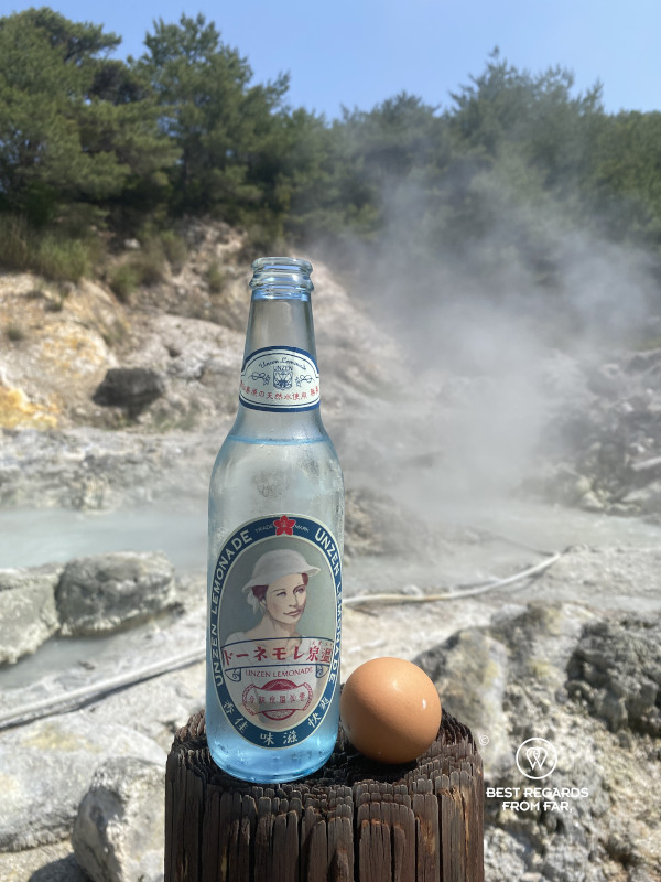 Egg boiled in Unzen Hell and local limonade in Kyushu with the hells in the background.