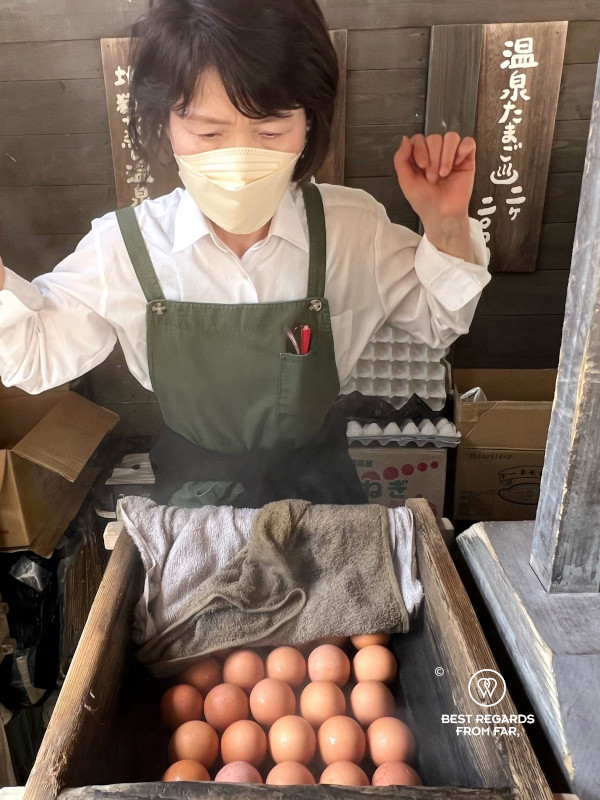 Woman boiling eggs in Unzen Hell on Kyushu.