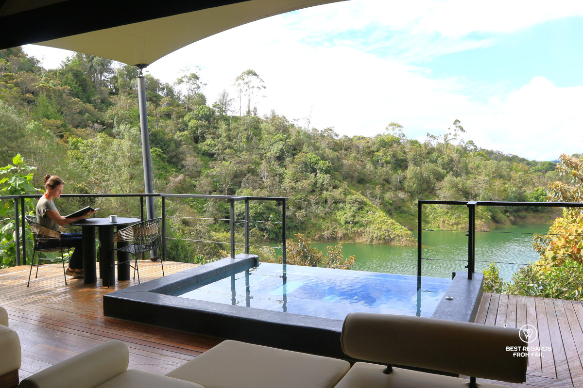 Woman reading a book by the private pool and overlooking the Guatape Lake on the terrasse of the Presidential Mush-Room-at Bosko.