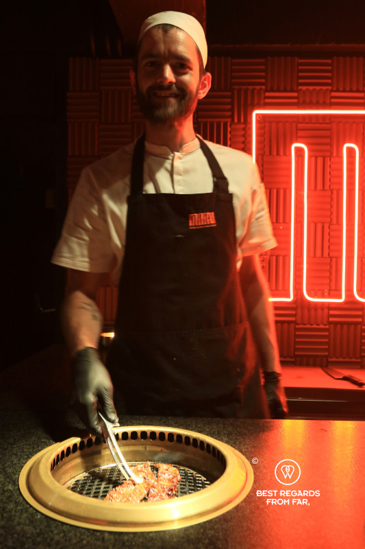 Cook grilling beef on a Korean barbecue at Maru in Cape Town.