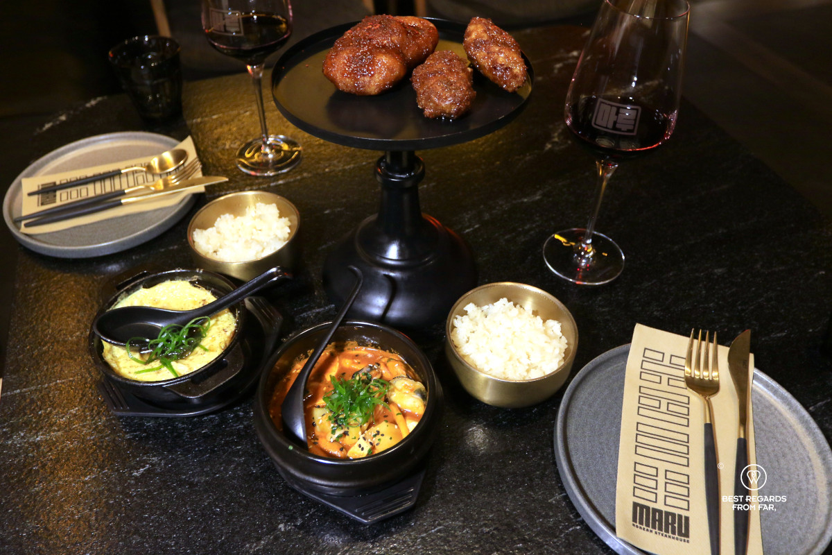Fried chicken presented on a dish and sides at Maru restaurant in Cape Town.