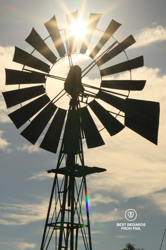 A typical Karoo windmill with the sun piercing through.