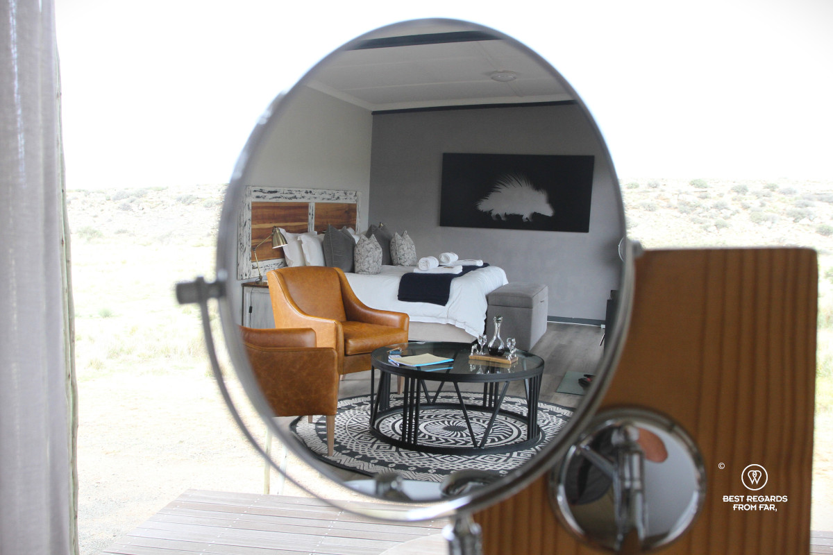 Room inside the Rogge Cloof cottage seen in a mirror.