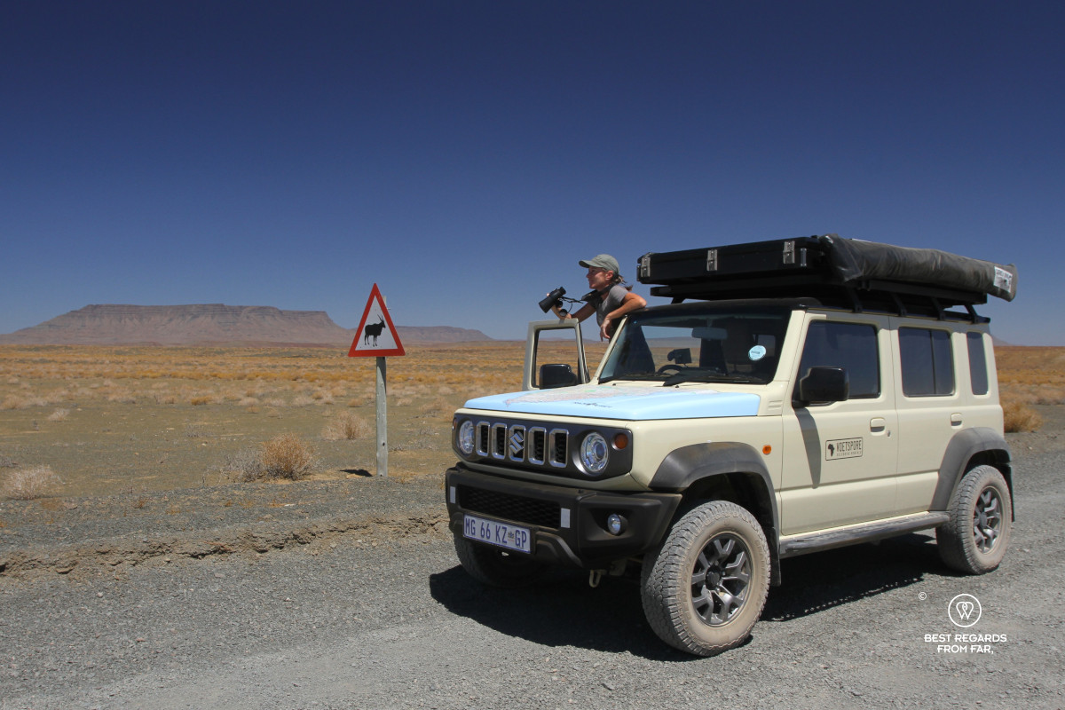 Author Claire Lessiau taking in the landscapes of the Tankwa Karoo from her geared up beige Suzuki Jimny.