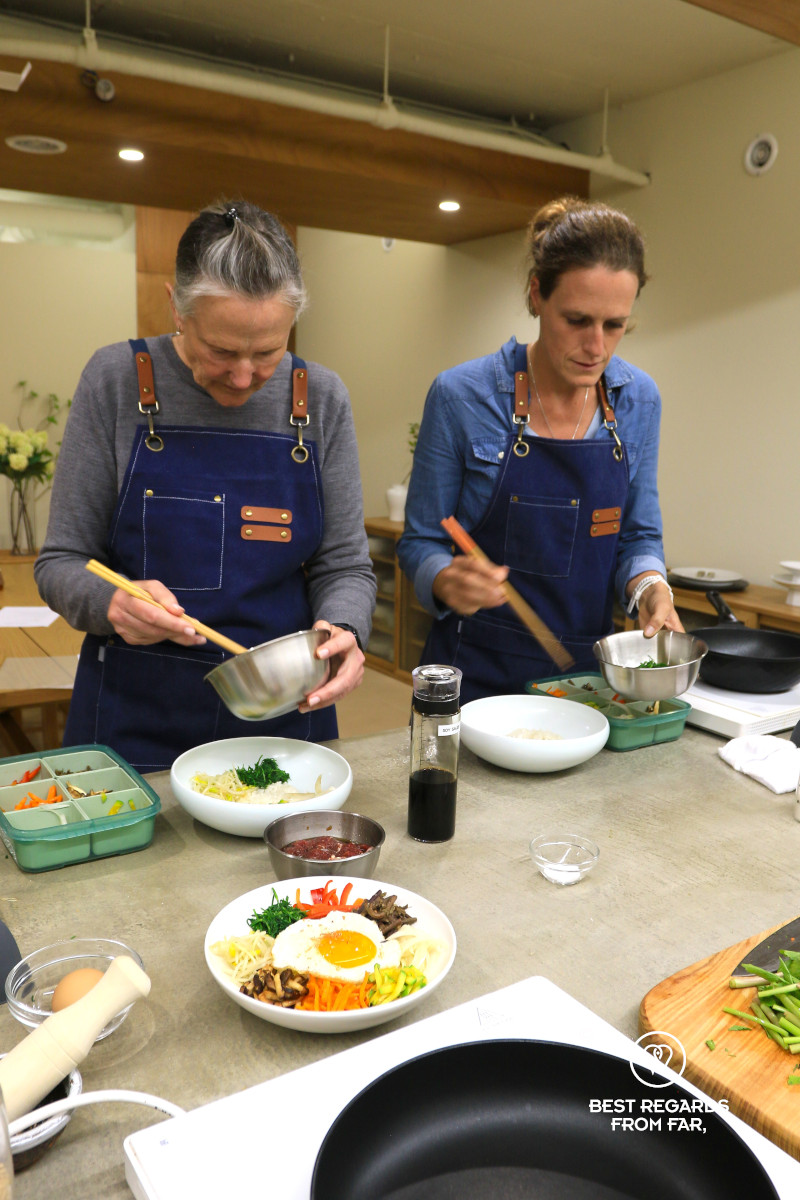 Guests preparing bibibmap during a Busan cooking class.