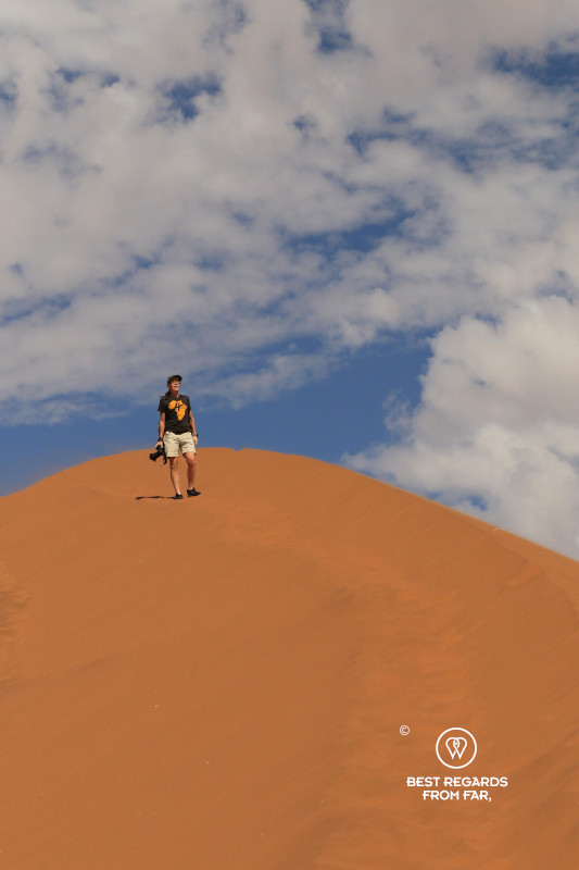 Photographer Claire Lessiau climbing Big Daddy dune in Namibia.