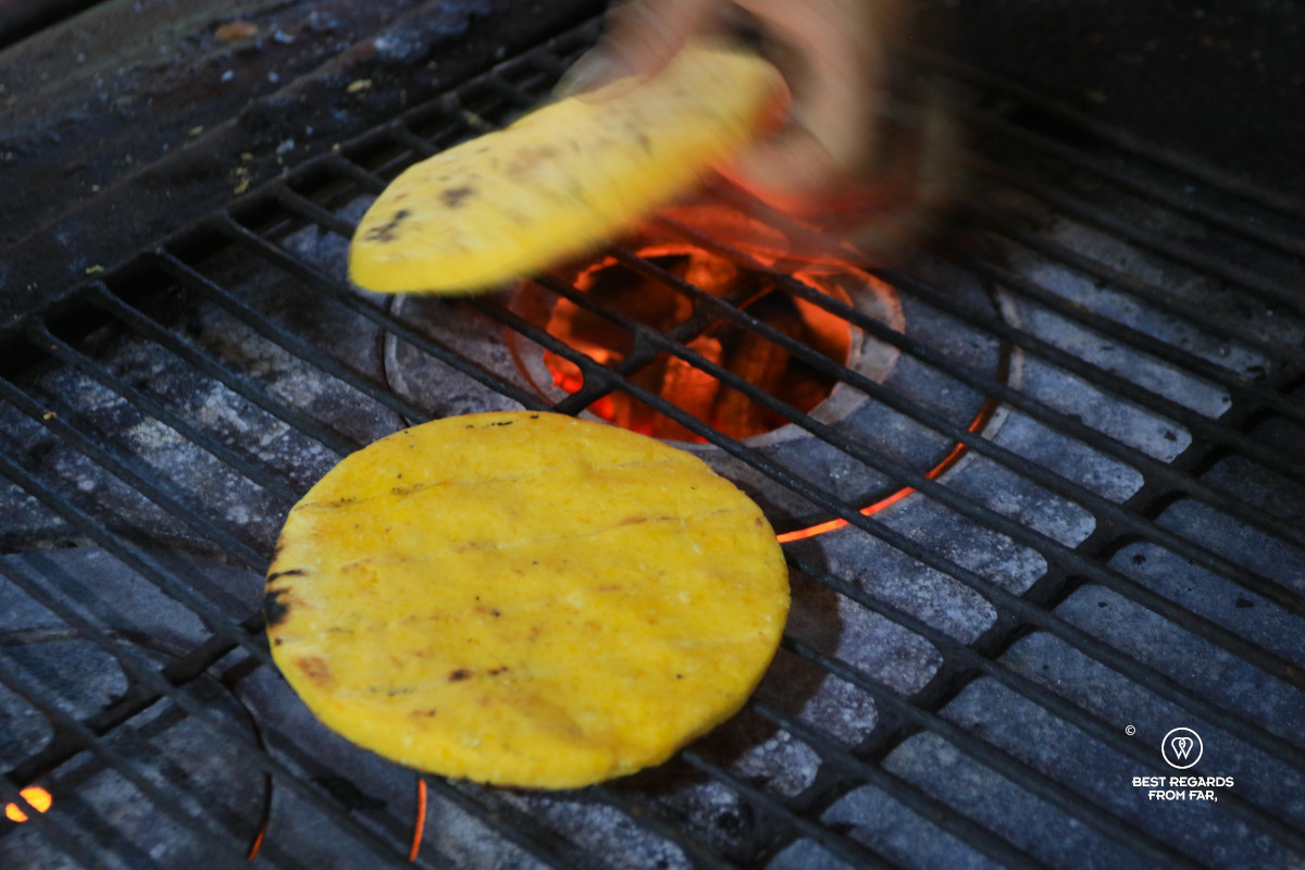 Arepas being cooked on the fire.