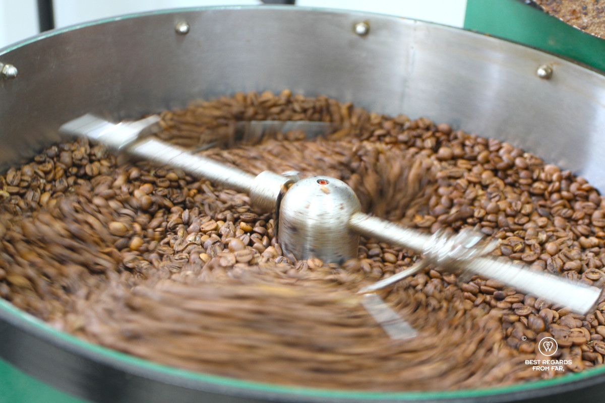 Machine rotating freshly roasted coffee beans.