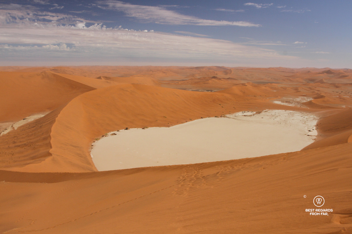 Deadvlei surrounded by red dunes seen from above.