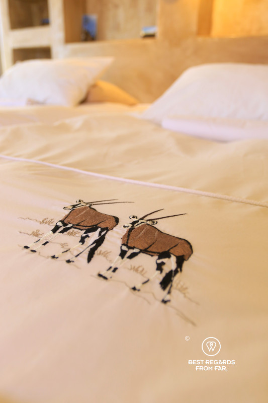 Embroidered oryx on a duvet.