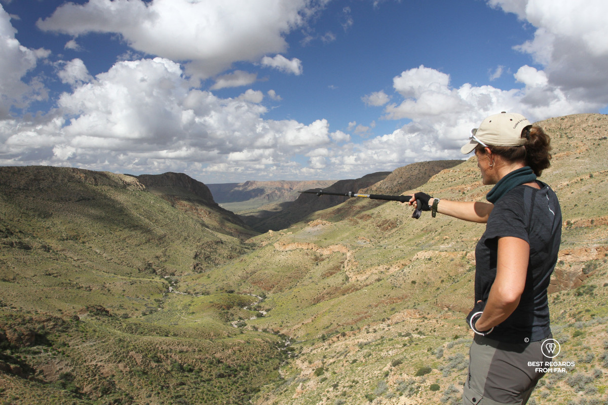 Author Marcella van Alphen pointing into the direction of the trail with a Vipole hiking pole.