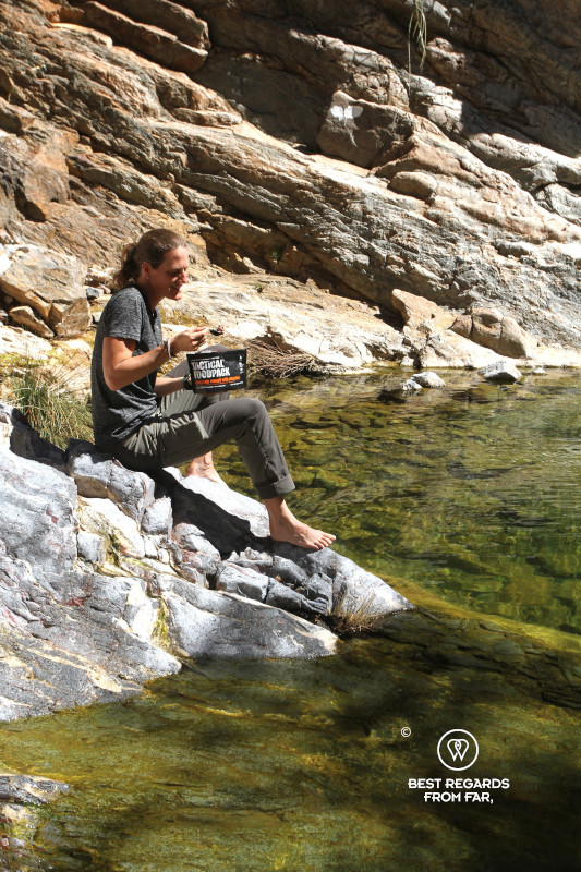 Author Marcella van Alphen enjoying a tactical foodpack breakfast by the rock pool in the Naukluft Mountains.