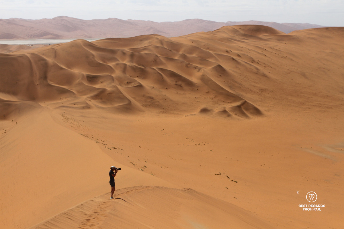 Photographer Marcella van Alphen taking a photo of Sossusvlei from the Big Daddy Dune.