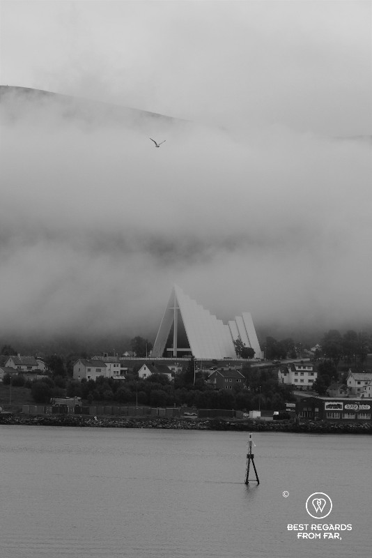 Black and white photo of the Arctic Cathedral in the clouds, Tromso, Norway.