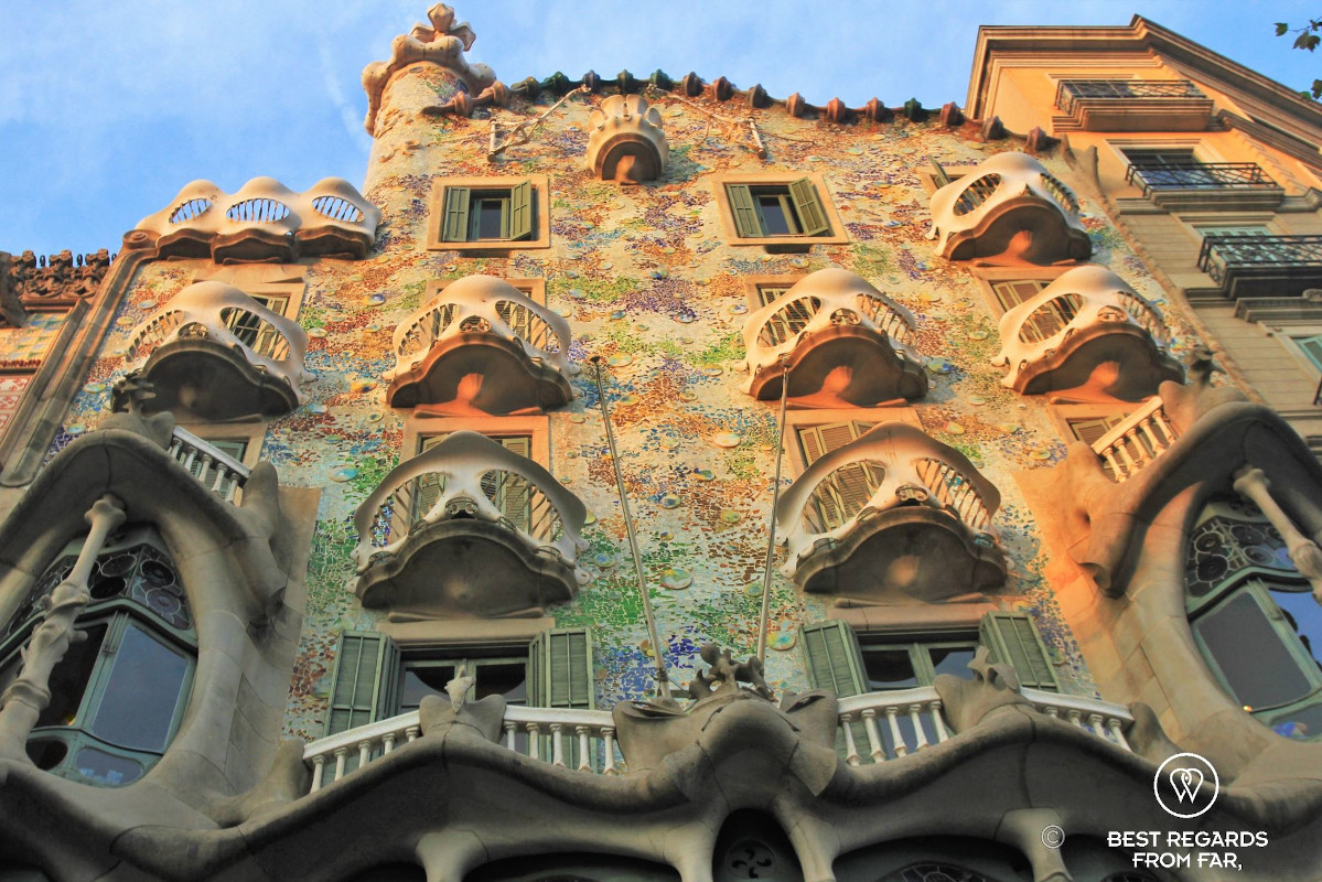 The joyful façade of Casa Batllo bathed by a sunrise light in Barcelona.