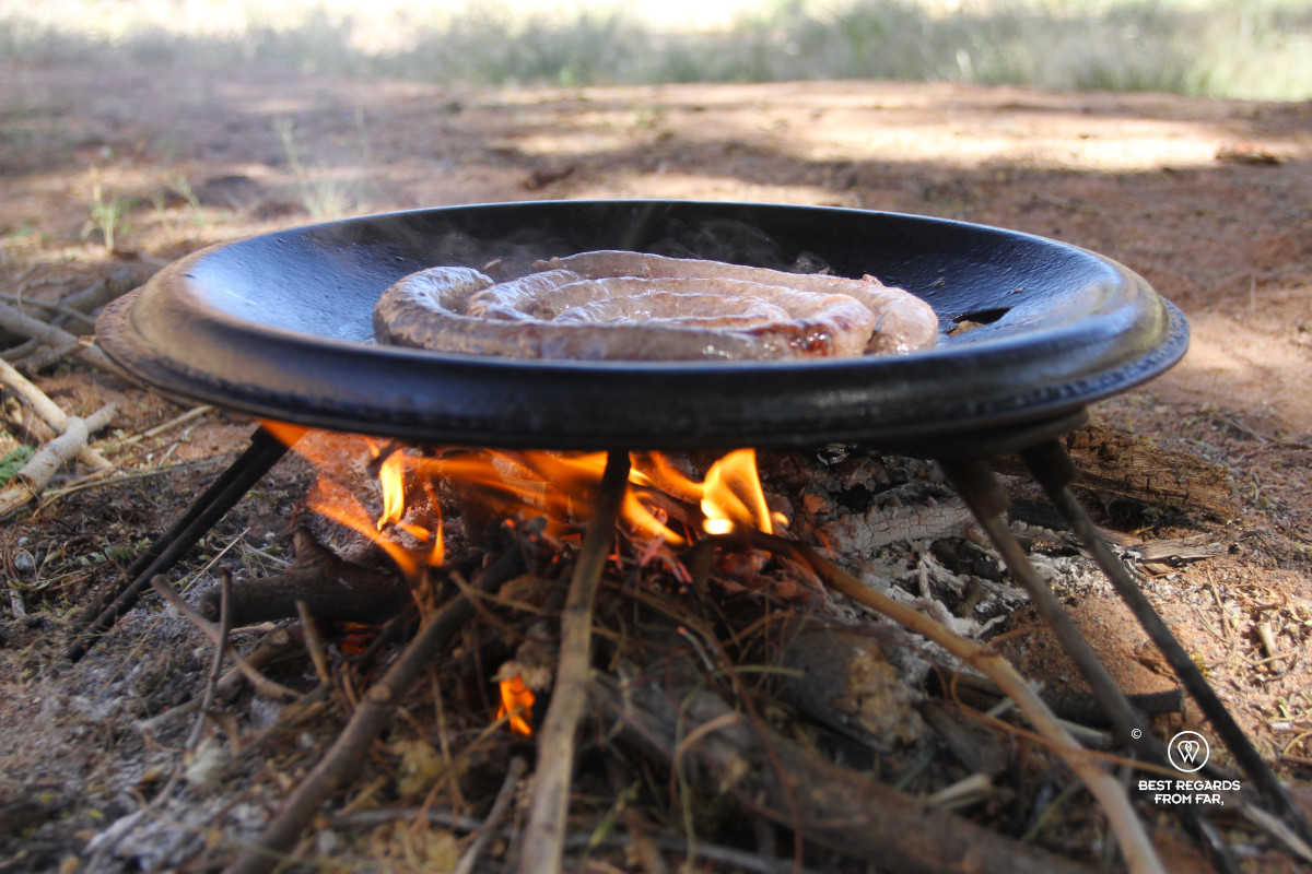 Sausage in a pan on an open fire.
