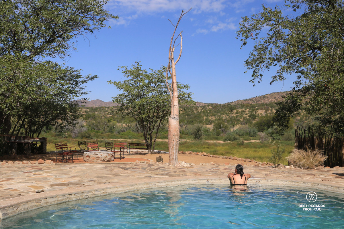 Cofounder Claire Lessiau taking in the green landscape around the dry riverbed from a pool.