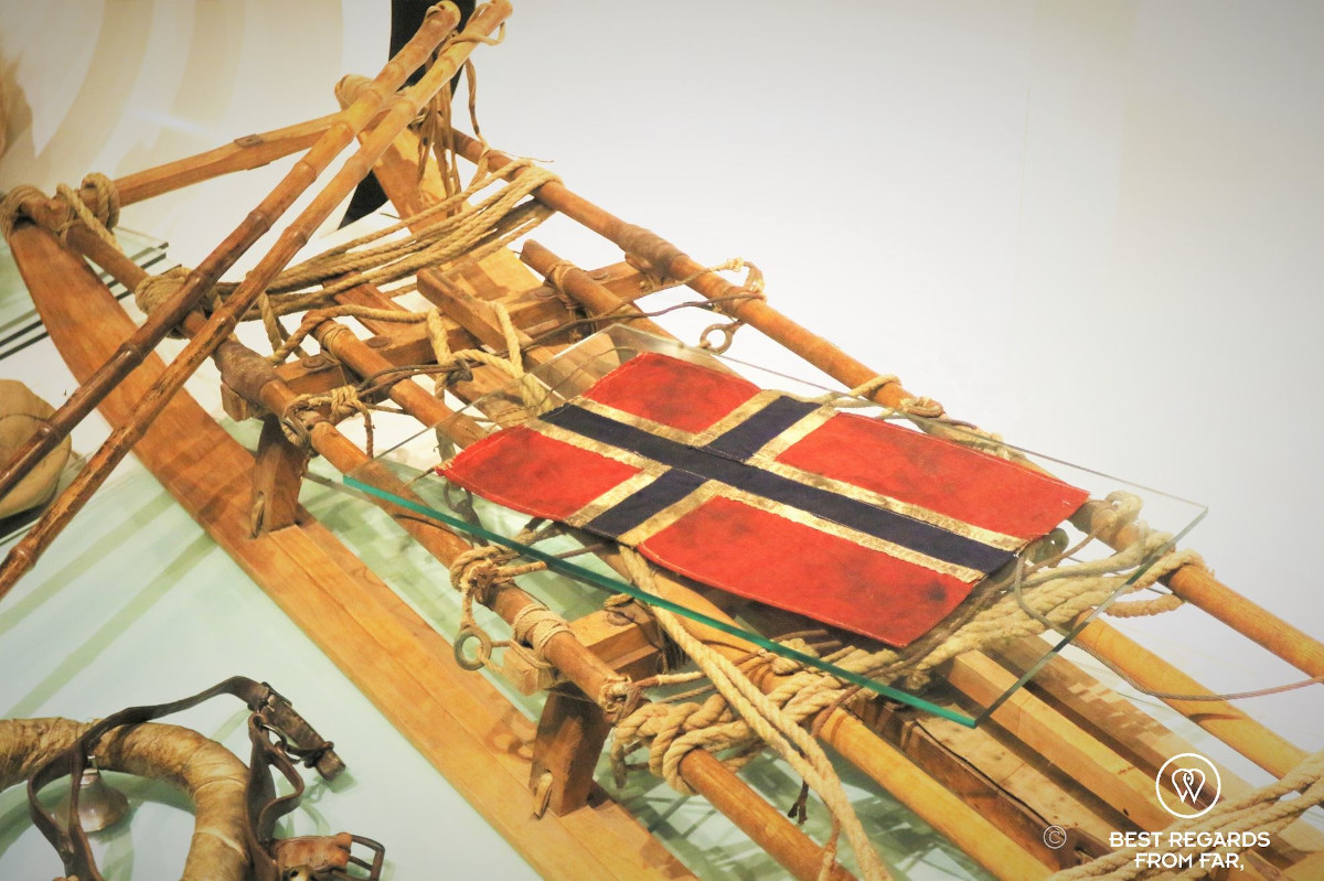 Sledge used during the first South Pole Expedition covered by the Norwegian flag at the Holmenkollen Ski Museum.