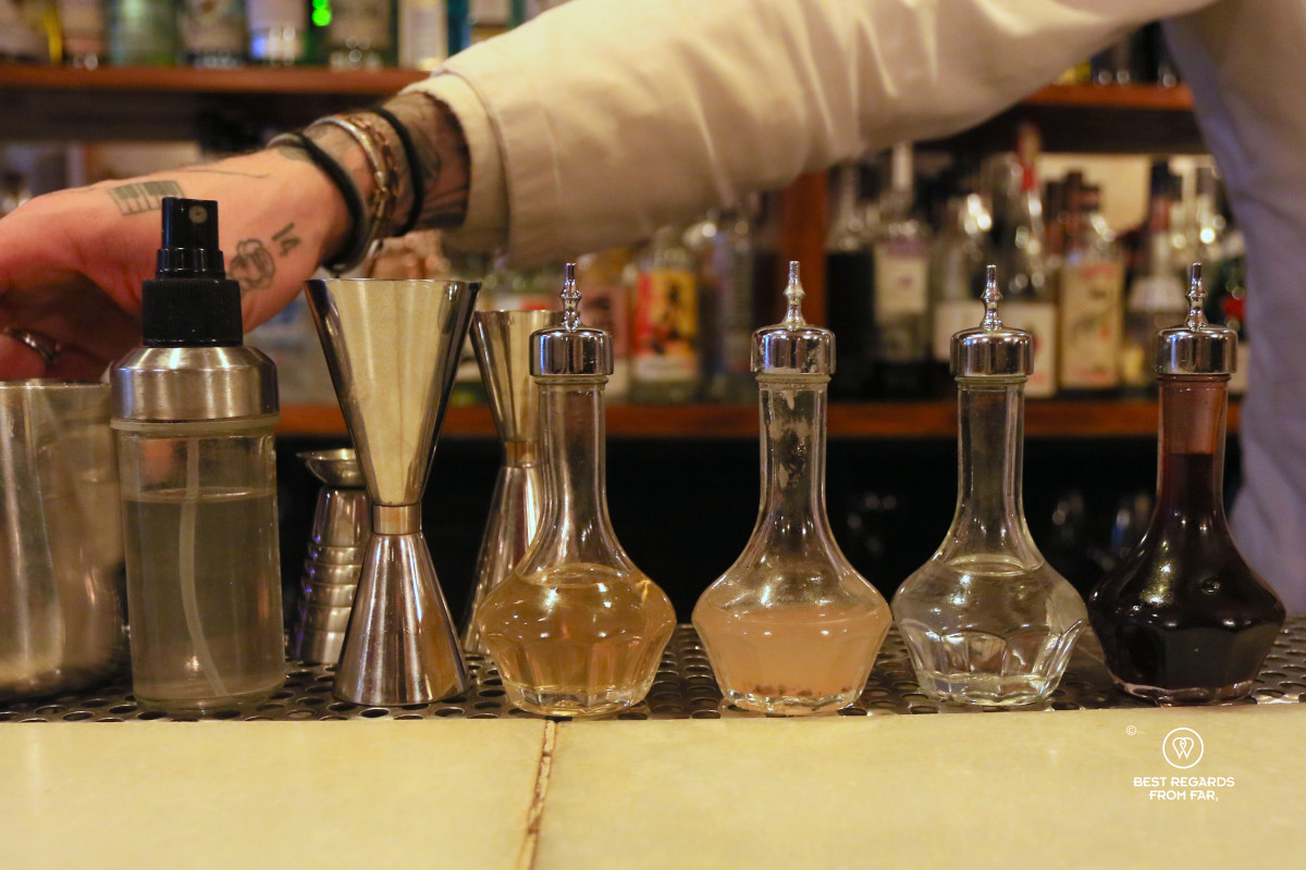 Various bottles with bitters in a cocktail bar.