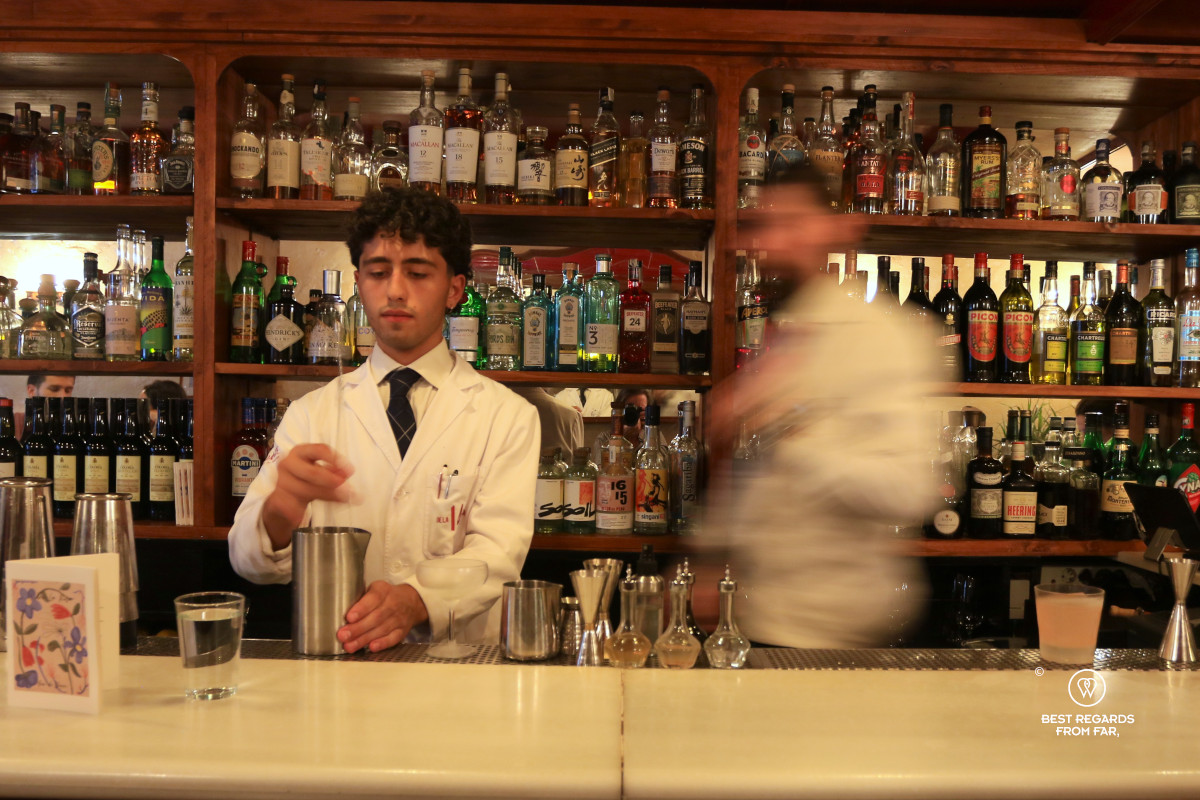 Bartender in a tie preparing a cocktail.