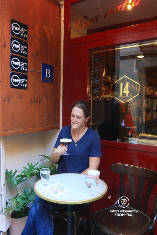 Woman drinking a cocktail outside.