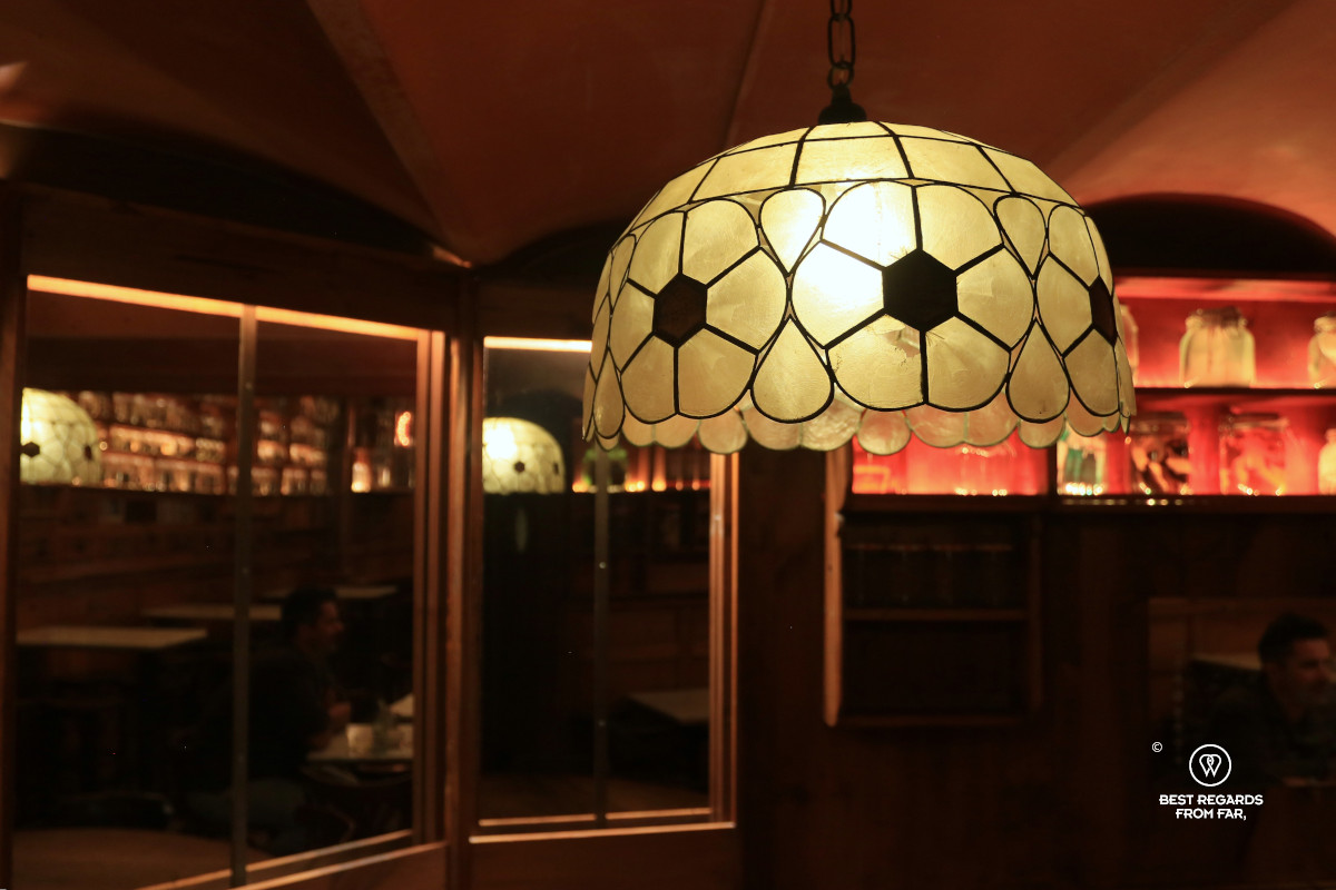 Art Nouveau lamp in a dimply lit establishment.