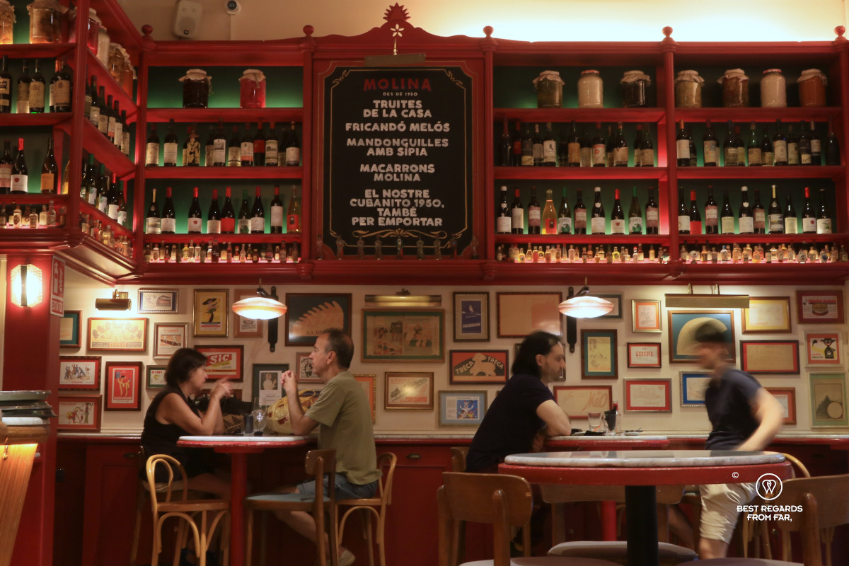 People having drinks in a retro-style bodega in Barcelona.