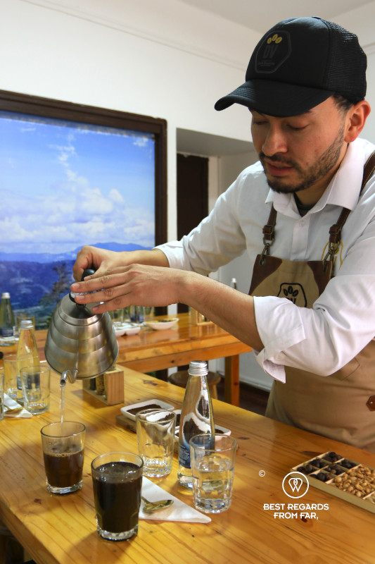 Man pouring coffee at, Divino Café, Bogota.