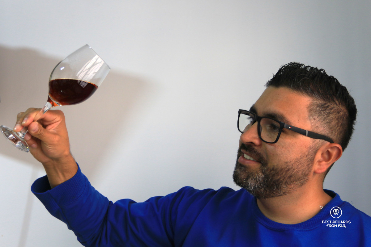 Leandro Galindo Giraldo with geisha coffee in a wine glass.