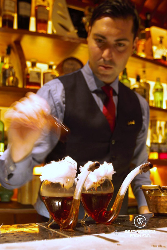 Barman adding the final touch to the Solera Presidente cocktail at El Paradiso bar in Barcelona.