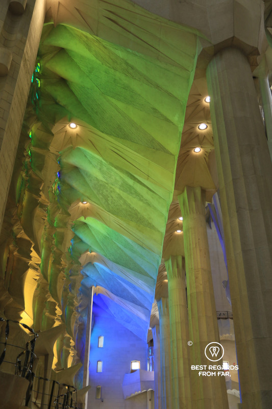 Green and blue light filtered through the stained-glass windows of La Sagrada Familia.