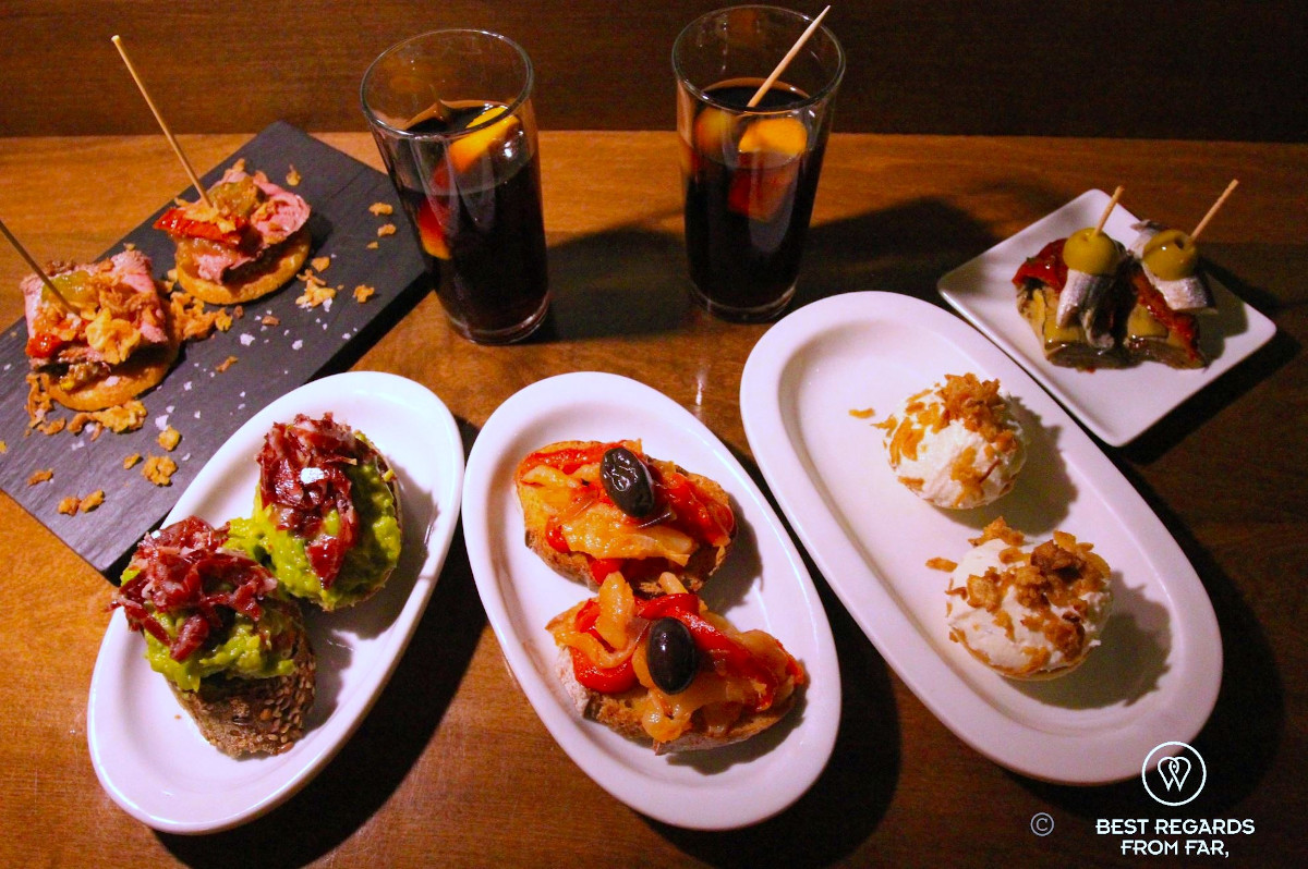 Typical bodega drinks and tapas on a wooden bar, Barcelona, Spain.