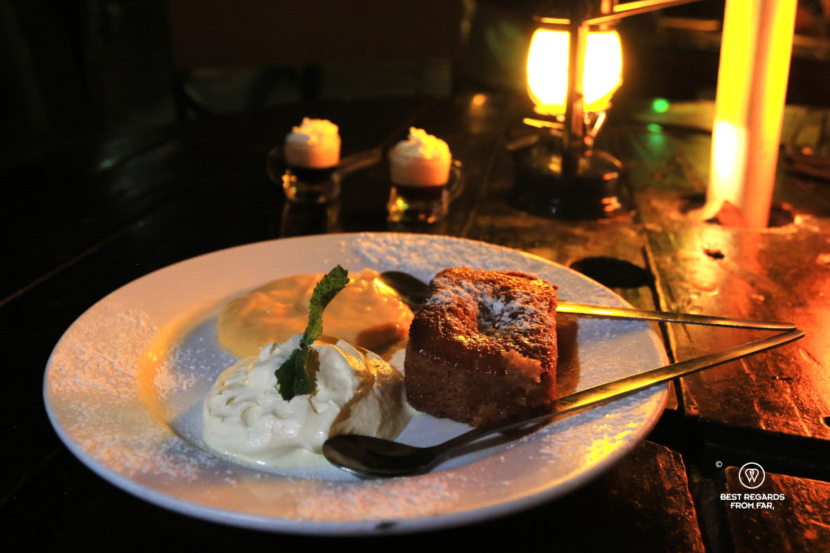 Malva pudding in a white plate at Joe's Beerhouse in Windhoek.