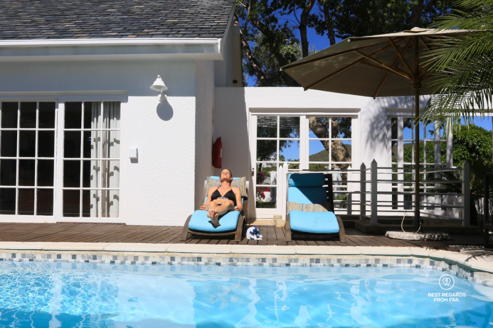 Woman tanning by the pool at The Belvedere Boutique Hotel in Windhoek, Namibia.